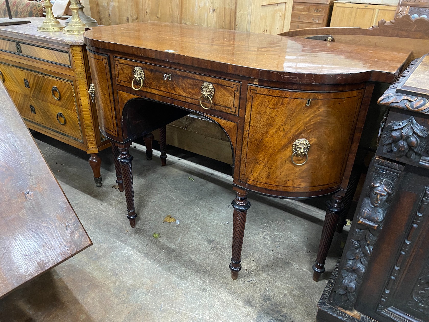 A Regency mahogany bow fronted sideboard, on reeded legs, width 136cm, depth 70cm, height 94cm